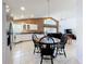 Open kitchen and dining area with black wood chairs and plenty of natural light at 2112 White Eagle St, Clermont, FL 34714