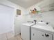Functional laundry room with appliances, upper shelving, and easy access to other parts of the home at 2112 White Eagle St, Clermont, FL 34714