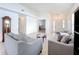Open-concept living room with light tile, neutral walls and view to bedroom and front entrance at 2112 White Eagle St, Clermont, FL 34714