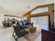 Spacious living room with vaulted ceiling and plenty of natural light open to the kitchen at 2112 White Eagle St, Clermont, FL 34714