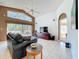Bright living room features tile flooring, a ceiling fan, and views of the lanai and backyard at 2112 White Eagle St, Clermont, FL 34714