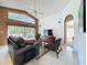 Comfortable living room with a vaulted ceiling, large windows, and a view of the pool at 2112 White Eagle St, Clermont, FL 34714