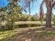 Scenic view of a tranquil pond, framed by lush trees and foliage, enhancing the property's natural beauty at 2112 White Eagle St, Clermont, FL 34714