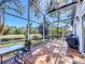 Inviting screened patio with brick floors and views of the lush backyard and tranquil pond at 2112 White Eagle St, Clermont, FL 34714