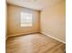 Cozy bedroom with neutral walls, hardwood floors, and a large window at 2624 Robert Trent Jones Dr # 633, Orlando, FL 32835
