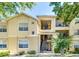 Charming condo exterior featuring a stairway and small balconies framed by lush greenery at 2624 Robert Trent Jones Dr # 633, Orlando, FL 32835