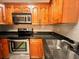 Well-equipped kitchen with granite countertops, stainless steel appliances, and ample wood cabinetry at 2624 Robert Trent Jones Dr # 633, Orlando, FL 32835