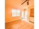 Bright living room with hardwood floors, large window, and built-in shelving at 2624 Robert Trent Jones Dr # 633, Orlando, FL 32835
