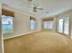 Spacious carpeted bedroom filled with natural light from windows and sliding doors at 307 Running Wind Ln, Maitland, FL 32751