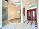 Elegant foyer featuring high ceilings, chandelier, tile flooring, and a decorative wood front door at 307 Running Wind Ln, Maitland, FL 32751