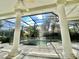 Screened-in pool area with white columns and brick flooring, offering a relaxed and enjoyable outdoor space at 307 Running Wind Ln, Maitland, FL 32751