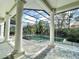 Enclosed pool area featuring columns, brick flooring, ceiling fan, and serene view at 307 Running Wind Ln, Maitland, FL 32751