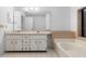 Bathroom with double vanity, soaking tub and tiled floor at 33333 Somerset Dr, Leesburg, FL 34788