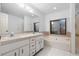 Bathroom with double vanity, soaking tub and large window, and tiled floor at 33333 Somerset Dr, Leesburg, FL 34788