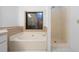 Bathroom features a soaking tub, a large window, and an adjacent shower at 33333 Somerset Dr, Leesburg, FL 34788