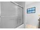 Bathroom with a glass-enclosed shower and tiled floors at 33333 Somerset Dr, Leesburg, FL 34788