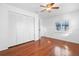 Light bedroom with hardwood floors, shuttered window, and large closet at 33333 Somerset Dr, Leesburg, FL 34788