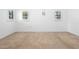 Bright, airy bedroom features neutral carpet, white walls, and natural light from multiple windows at 33333 Somerset Dr, Leesburg, FL 34788