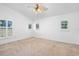 Empty bedroom features carpeted floors and three windows with shutters for natural light at 33333 Somerset Dr, Leesburg, FL 34788