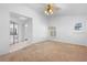 Neutral bedroom with ceiling fan and view into the bathroom and to the exterior through window shutters at 33333 Somerset Dr, Leesburg, FL 34788