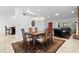 Inviting dining space adjacent to the living area with a large wooden table and bright lighting at 33333 Somerset Dr, Leesburg, FL 34788