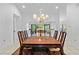 Formal dining room featuring a wooden table, chandelier, and views to the lanai at 33333 Somerset Dr, Leesburg, FL 34788