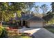 Charming single-story home featuring a well-manicured lawn and a spacious two-car garage at 33333 Somerset Dr, Leesburg, FL 34788