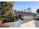 Charming single-story home featuring a well-manicured lawn and a spacious two-car garage at 33333 Somerset Dr, Leesburg, FL 34788