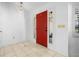 Bright foyer with tile flooring, decorative lighting, and a vibrant red front door at 33333 Somerset Dr, Leesburg, FL 34788