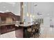 Spacious kitchen with granite counters, pendant lighting, stainless appliances, and a large center island at 33333 Somerset Dr, Leesburg, FL 34788
