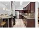 Gourmet kitchen with stainless steel appliances, granite countertops, and rich wood cabinetry at 33333 Somerset Dr, Leesburg, FL 34788