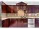 Well-appointed kitchen with custom cabinetry, granite countertops, and stainless steel appliances at 33333 Somerset Dr, Leesburg, FL 34788