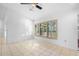 Bright and airy living area featuring shuttered windows and tiled floors at 33333 Somerset Dr, Leesburg, FL 34788