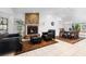 Cozy living room and dining area with a brick fireplace, comfortable seating, and stylish decor at 33333 Somerset Dr, Leesburg, FL 34788
