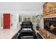 Inviting living room featuring a brick fireplace, bay window, and elegant leather seating at 33333 Somerset Dr, Leesburg, FL 34788