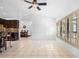 Bright living room features tile flooring, shuttered windows, and easy access to the kitchen and dining area at 33333 Somerset Dr, Leesburg, FL 34788