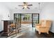 Cozy living room with slate tile flooring, bar area, and glass doors to the lanai at 33333 Somerset Dr, Leesburg, FL 34788