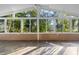Bright sunroom with large windows offering backyard views and a tile floor at 33333 Somerset Dr, Leesburg, FL 34788