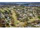 Expansive aerial view of a community near a golf course and lakes, showcasing the landscape and neighborhood at 3519 Backspin Ln, Orlando, FL 32804