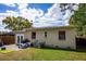 Fenced backyard features a patio, play area, and lush lawn at 3519 Backspin Ln, Orlando, FL 32804