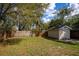 Fenced backyard has grass and shed, offering privacy and storage at 3519 Backspin Ln, Orlando, FL 32804