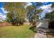 Grassy backyard features a shed and wood fence at 3519 Backspin Ln, Orlando, FL 32804