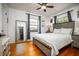 Bedroom boasts a large bed, full-length mirror, and hardwood floors at 3519 Backspin Ln, Orlando, FL 32804