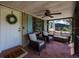 Cozy front porch featuring a seating area with a ceiling fan and charming decor at 3519 Backspin Ln, Orlando, FL 32804