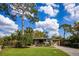 Charming single-story home featuring a well-manicured lawn, mature trees, and a cozy covered porch at 3519 Backspin Ln, Orlando, FL 32804