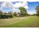 Picturesque golf course featuring manicured greens, trees, and blue sky, perfect for golf enthusiasts at 3519 Backspin Ln, Orlando, FL 32804