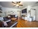 Spacious living room with hardwood floors, a comfortable sofa, and a large flat-screen TV at 3519 Backspin Ln, Orlando, FL 32804