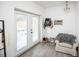 Bright sun room with tiled floors, a comfortable armchair, and backyard access at 3519 Backspin Ln, Orlando, FL 32804