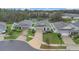An aerial view displays neatly arranged homes with manicured lawns in a peaceful community near a lake at 4009 Swan Goose Ct, Okahumpka, FL 34762