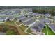 An aerial view of a residential neighborhood showcases neatly planned homes surrounded by natural landscapes at 4009 Swan Goose Ct, Okahumpka, FL 34762